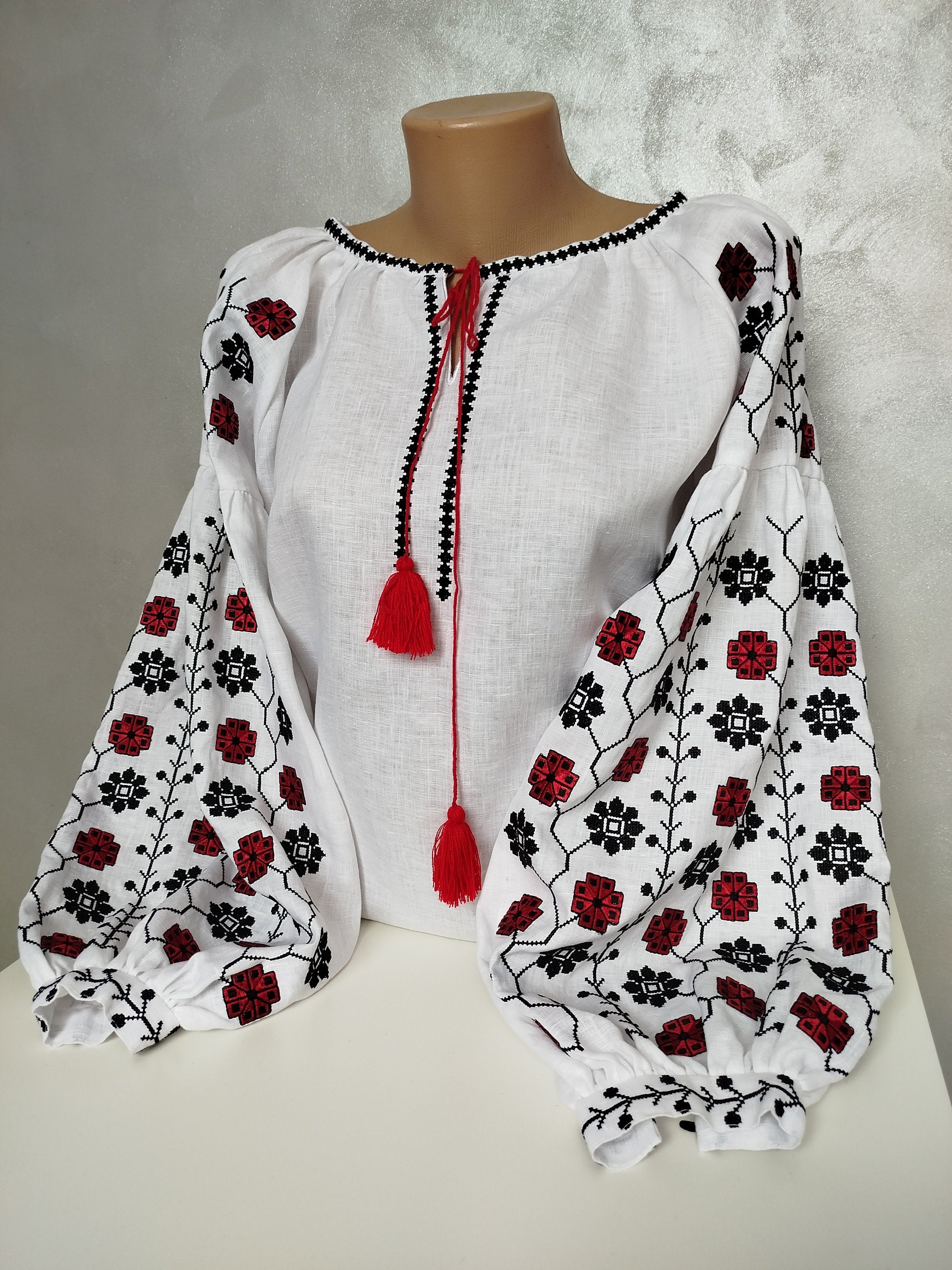 Women's Ukrainian Vyshyvanka embroidered linen shirt with traditional red and black folk motifs, featuring cross-stitch craftsmanship.