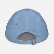 Back view of blue youth baseball cap with adjustable strap and eyelets for ventilation, made from bio-washed chino cotton twill.