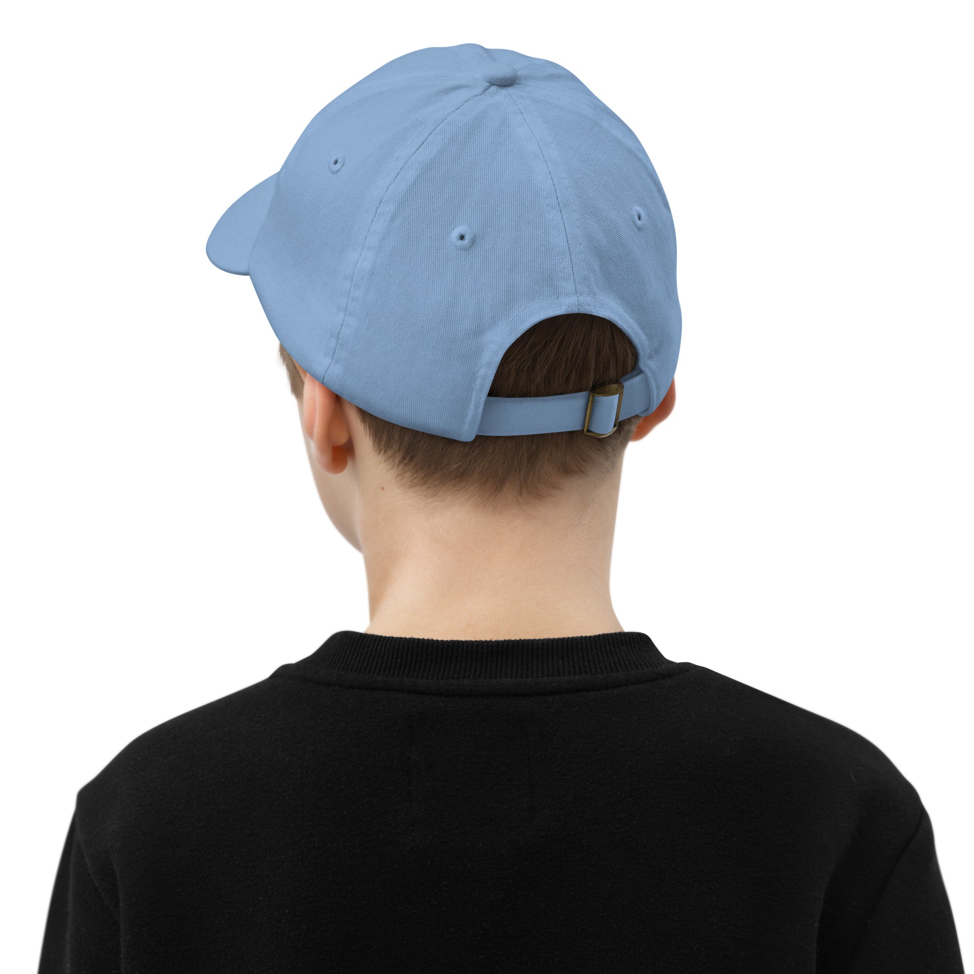 Child wearing a blue adjustable baseball cap with ventilation eyelets, ideal for active kids and outdoor activities.