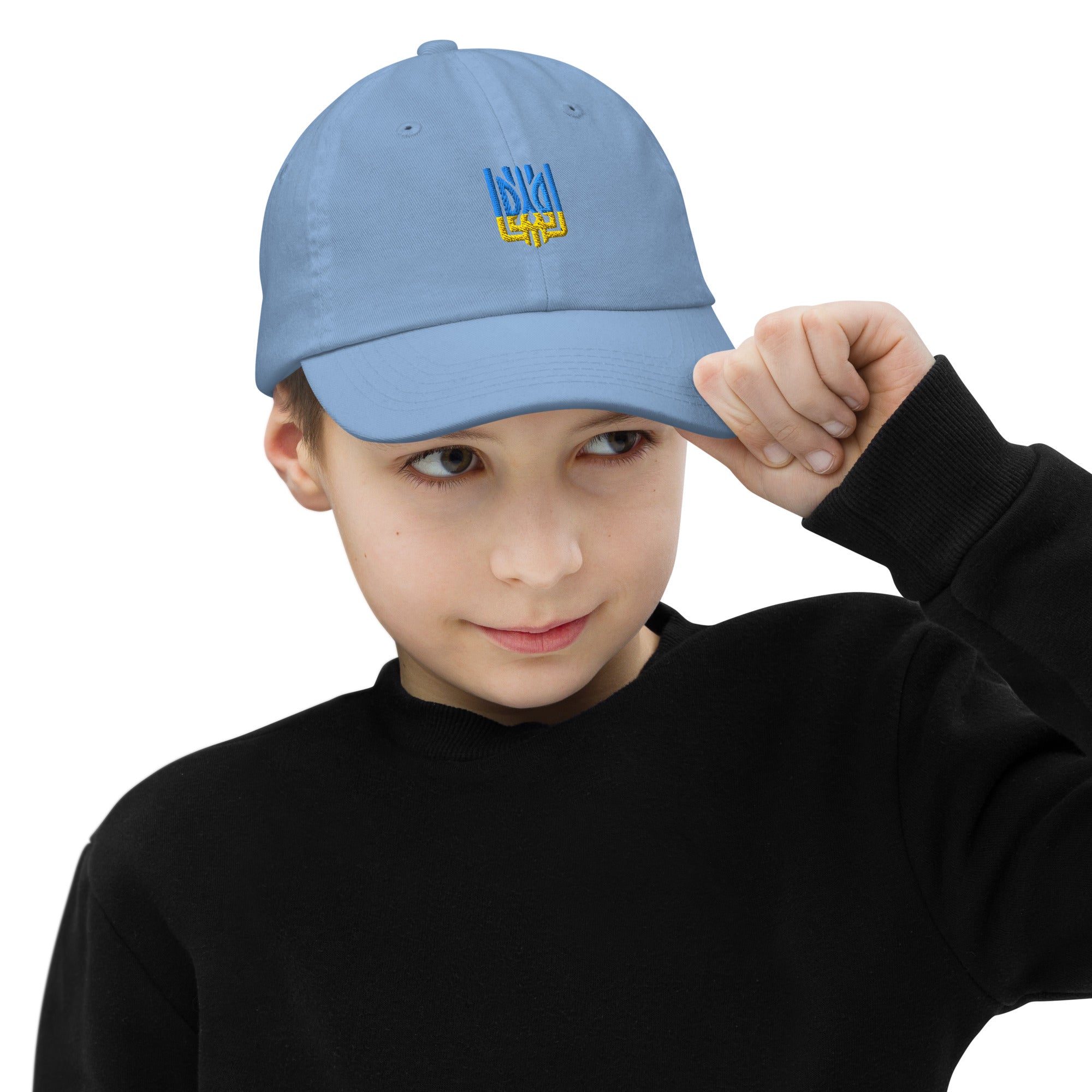 Child wearing blue youth baseball cap with Ukrainian Tryzub emblem, featuring breathable design and adjustable strap for active kids.