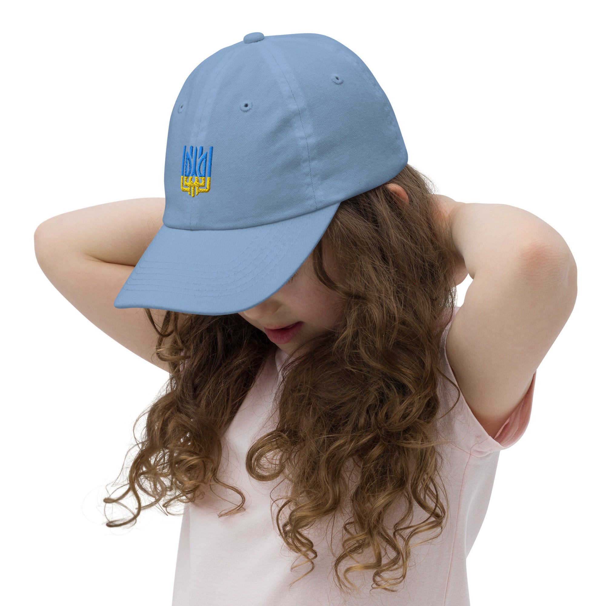 Child wearing blue youth baseball cap with Ukrainian Tryzub emblem, breathable and adjustable, perfect for outdoor activities.