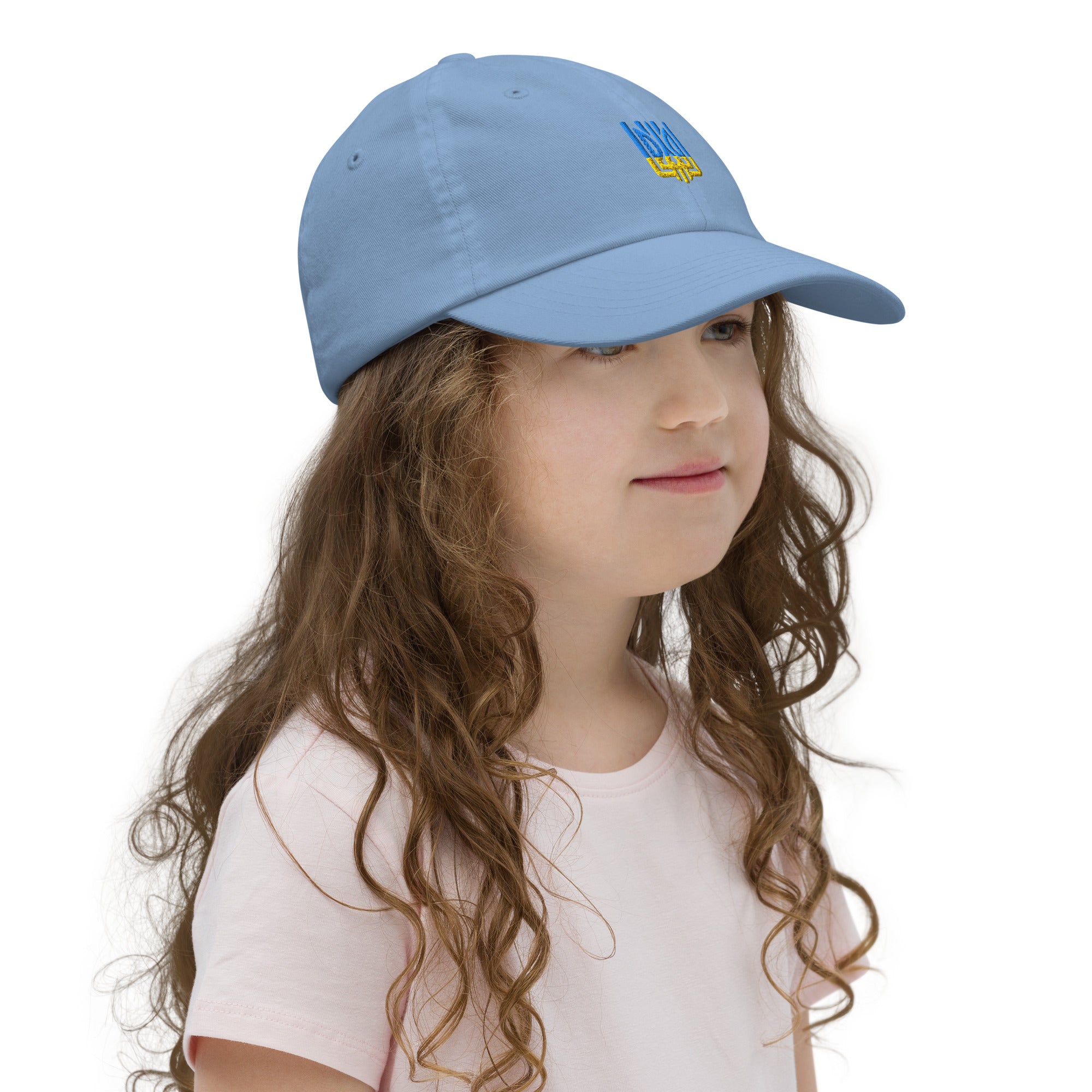 Youth wearing a blue baseball cap with Ukrainian Tryzub emblem, showcasing adjustable fit and breathable design. Perfect for active kids.
