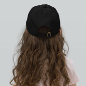 Child wearing a black adjustable baseball cap, breathable and perfect for outdoor activities. Ideal for active kids, features Ukrainian Tryzub.