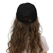 Back view of youth wearing a breathable black baseball cap with adjustable strap, ideal for sports and outdoor activities.