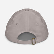Back view of youth baseball cap with adjustable strap, made from bio-washed chino cotton twill, featuring ventilation eyelets for breathability.
