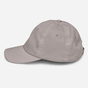 Side view of youth baseball cap with Ukrainian Tryzub, breathable and adjustable, made from soft bio-washed chino cotton twill.