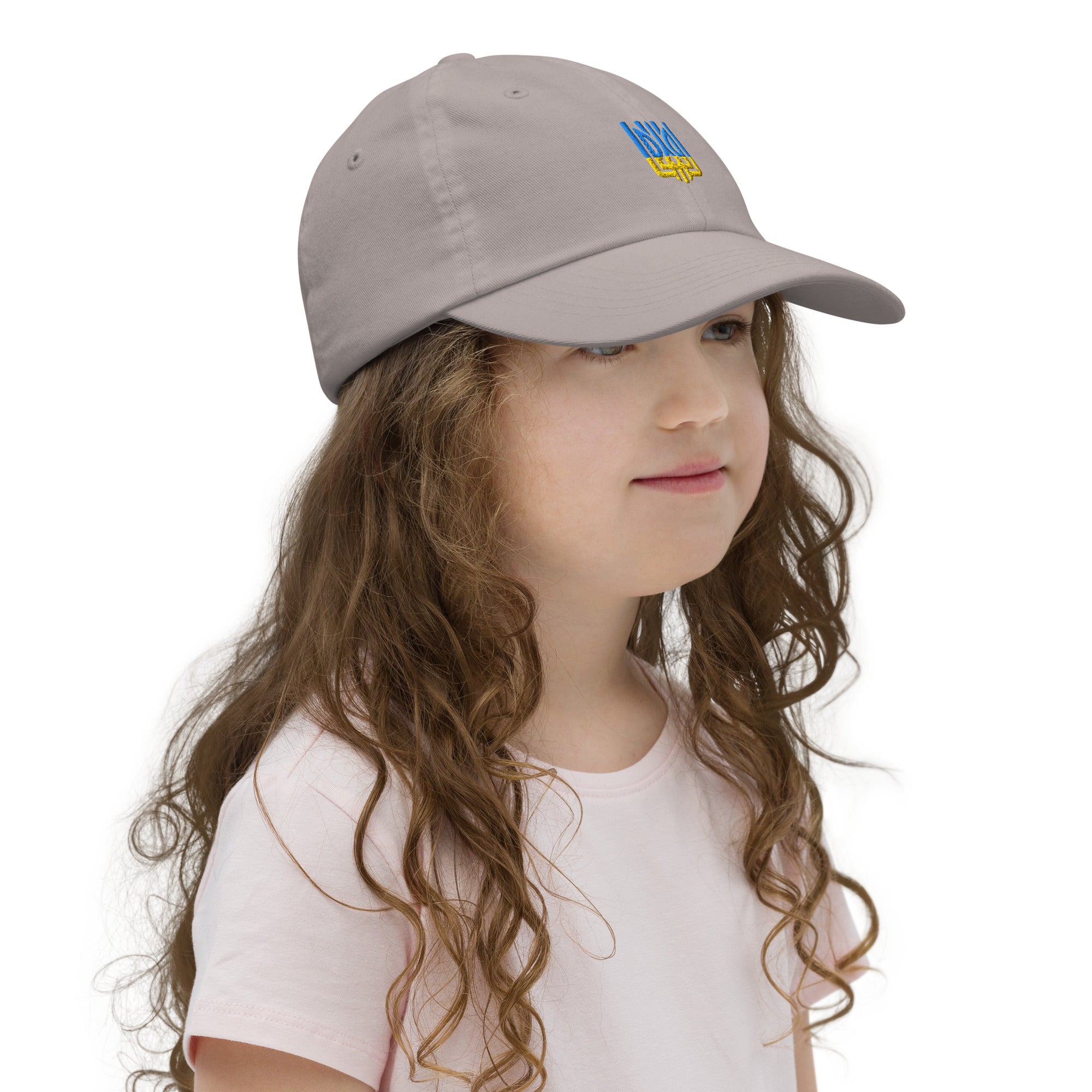 Child wearing a youth baseball cap with a Ukrainian Tryzub emblem, showcasing breathable and adjustable design ideal for active kids.