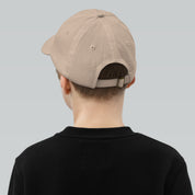 Child wearing beige youth baseball cap with adjustable strap and Tryzub emblem, ideal for active kids.