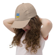 Youth baseball cap with Ukrainian Tryzub emblem worn by a child, featuring breathable fabric and adjustable strap for active kids.