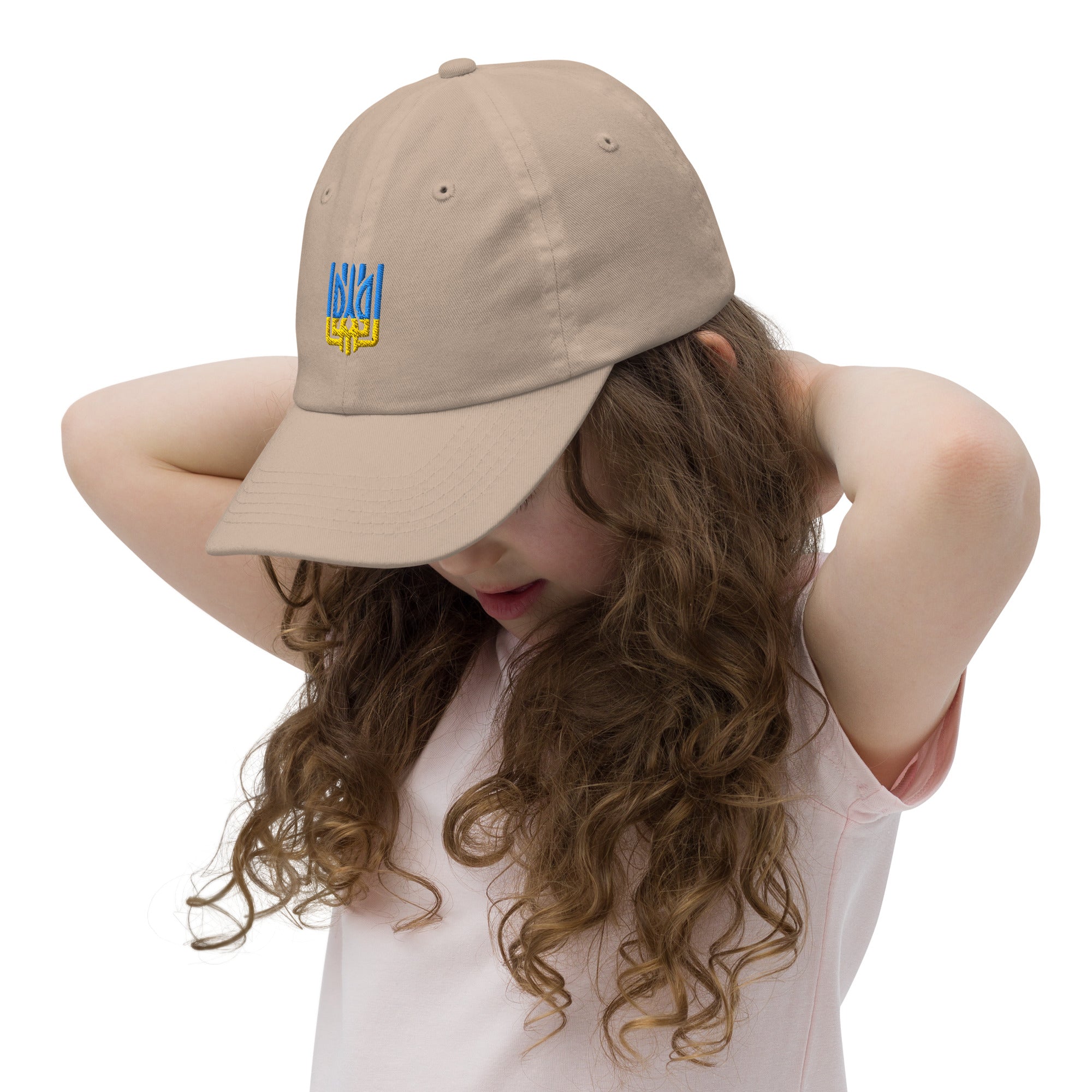 Youth baseball cap with Ukrainian Tryzub emblem worn by a child, featuring breathable fabric and adjustable strap for active kids.