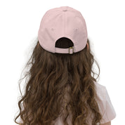 Back view of a child wearing an adjustable pink youth baseball cap, suitable for active kids, with breathable material.