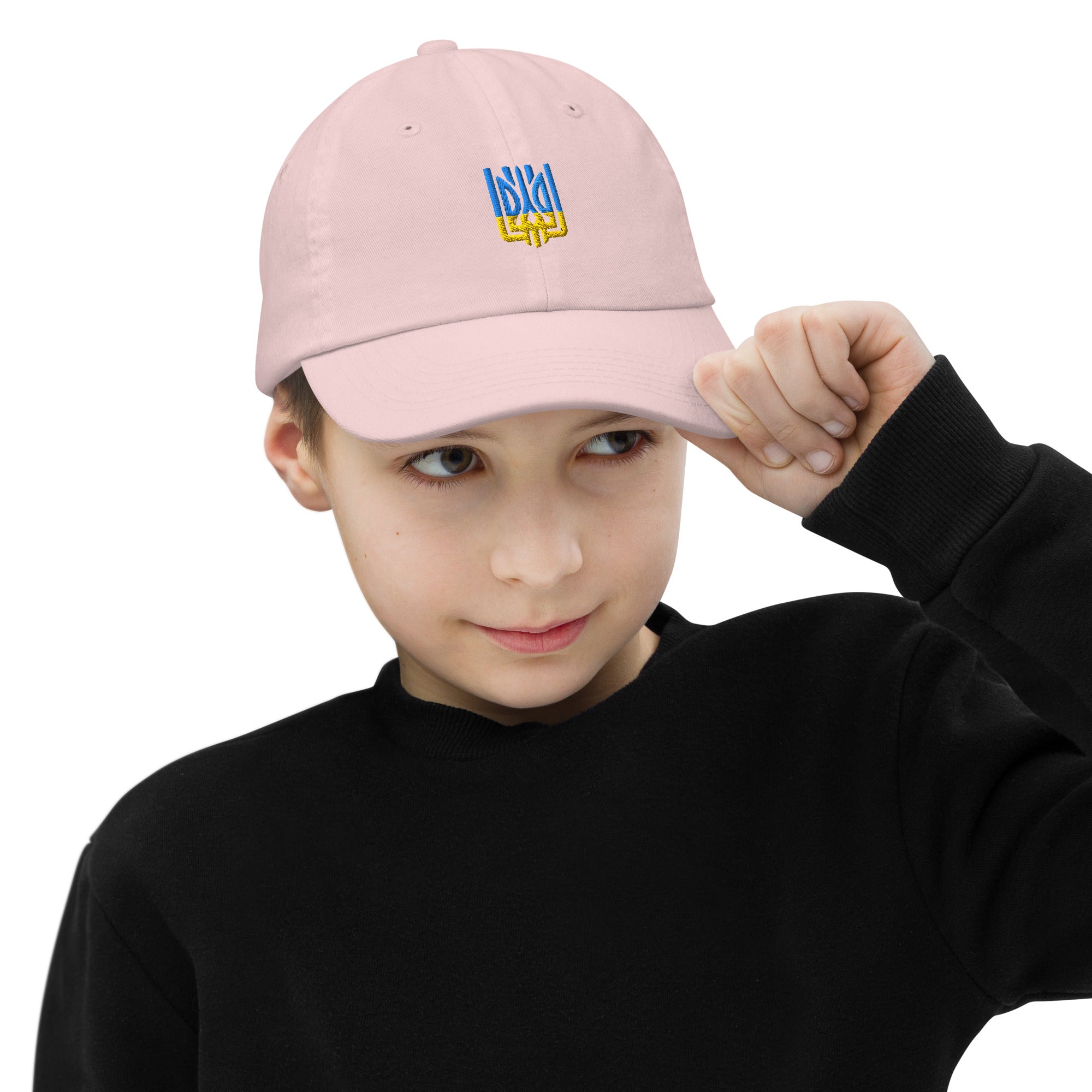 Youth wearing a pink baseball cap with Ukrainian Tryzub emblem, adjustable strap, and breathable design, ideal for active kids.