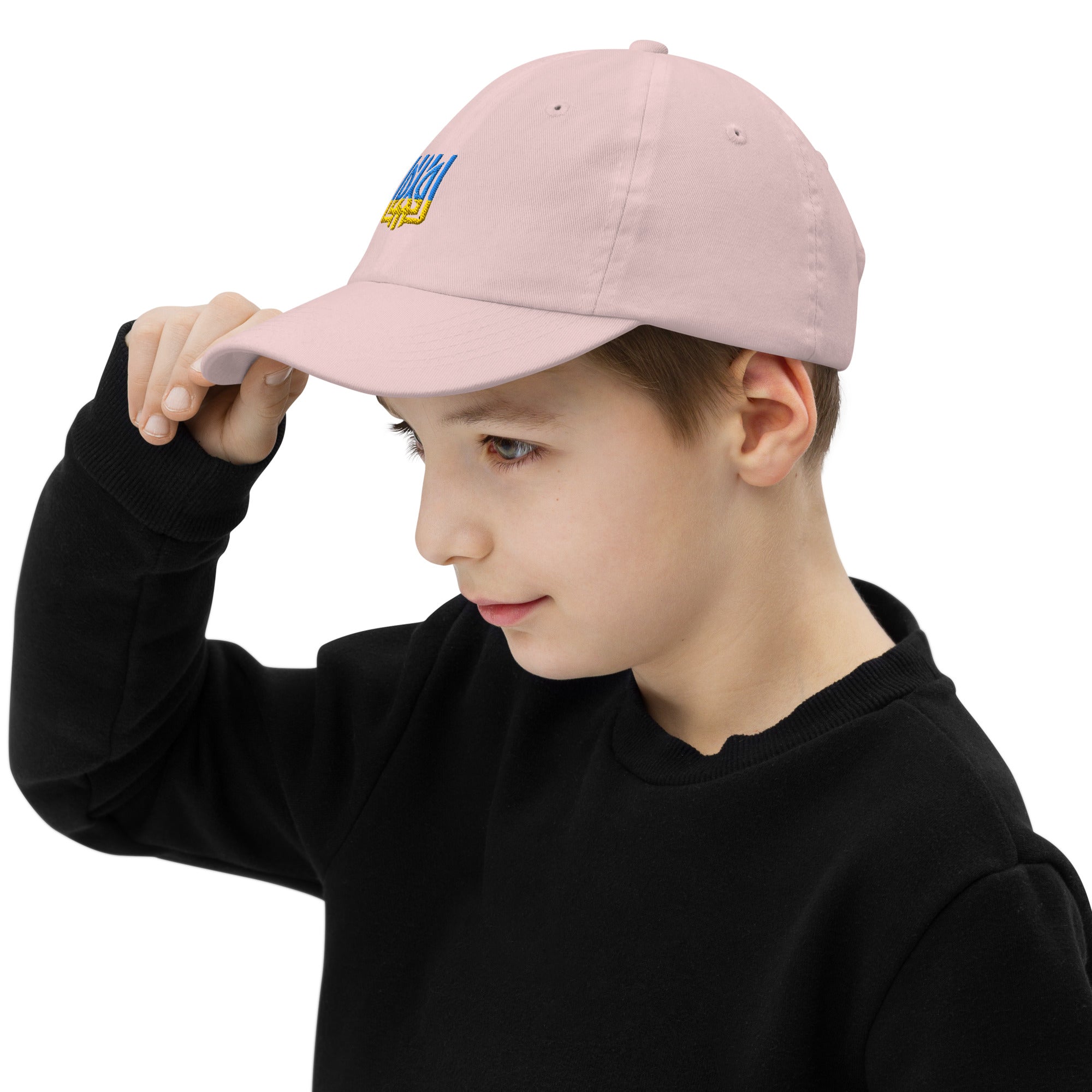 Child wearing a youth baseball cap with Ukrainian Tryzub emblem, showcasing adjustable strap and breathable design for active kids.