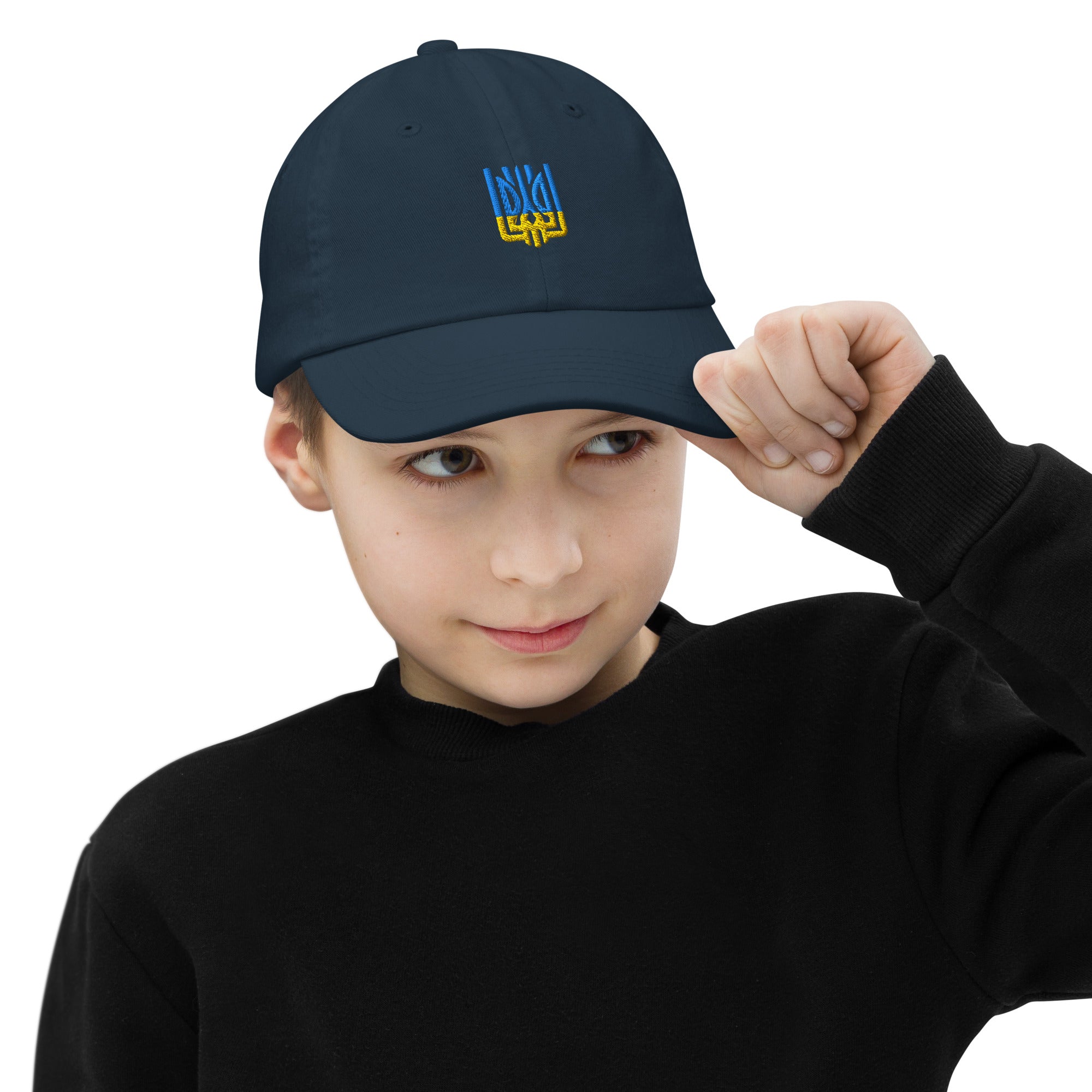 Child wearing a navy youth baseball cap with Ukrainian Tryzub emblem, soft chino cotton twill, adjustable strap, breathable design.