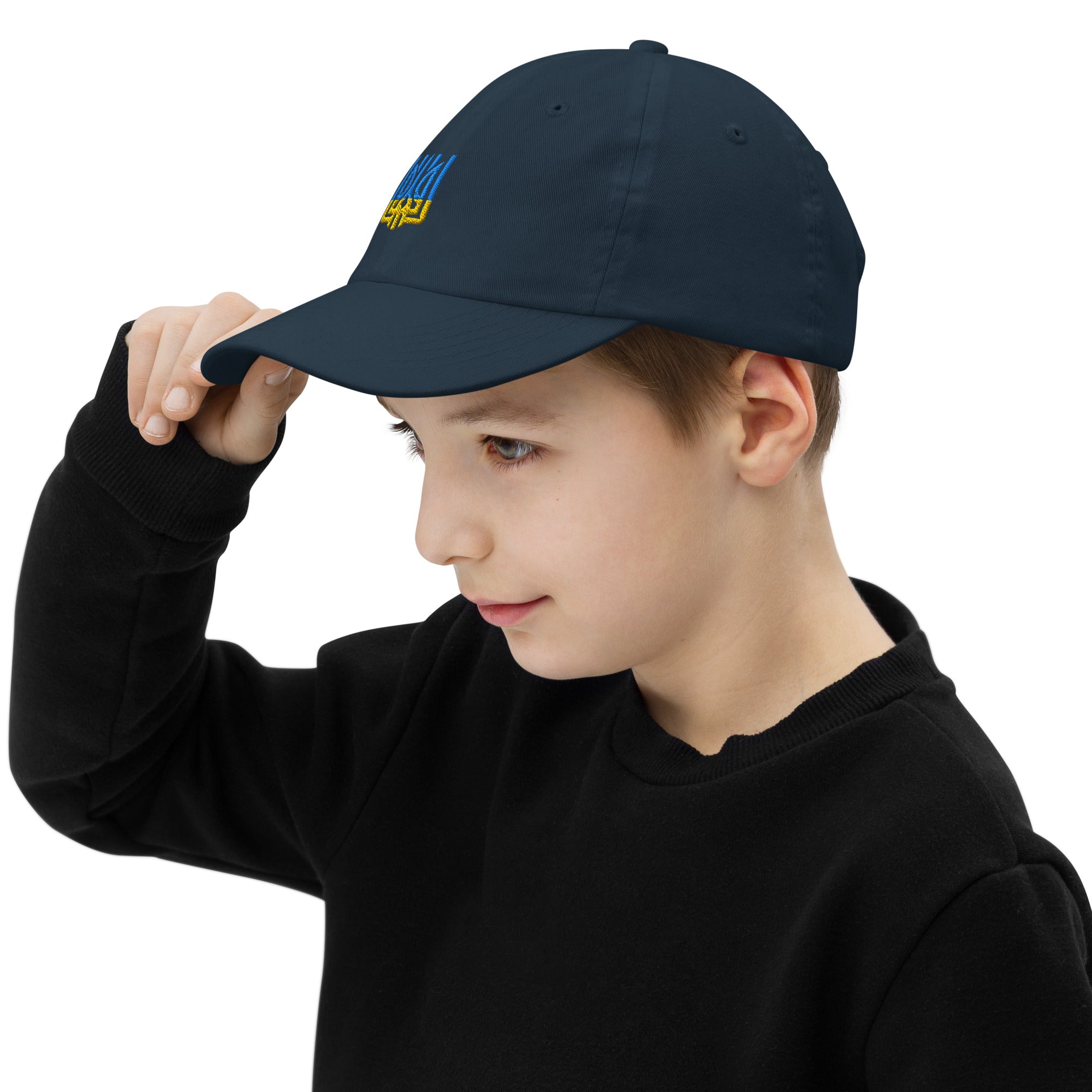 Youth wearing Ukrainian Tryzub baseball cap; breathable, adjustable, perfect for sports and outdoor activities.