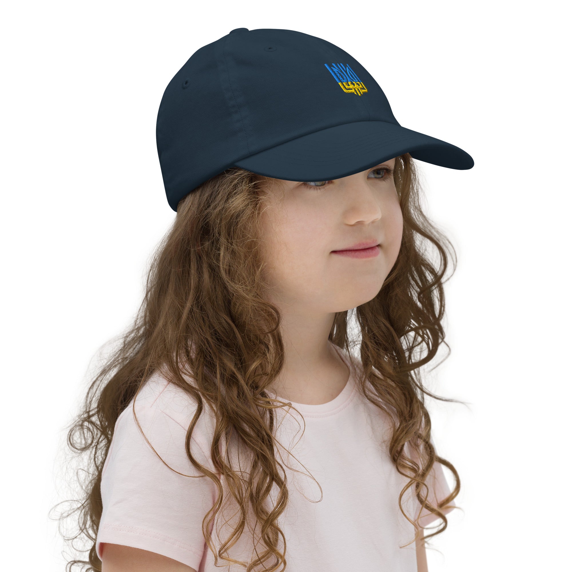 Young girl wearing a navy baseball cap with Ukrainian Tryzub for kids, breathable and adjustable for sports and outdoor activities.