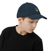 Youth baseball cap with Ukrainian Tryzub, breathable and adjustable, worn by a child. Ideal for active kids, featuring a stylish and patriotic design.