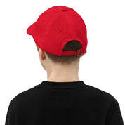 Back view of child wearing red youth baseball cap with adjustable strap.
