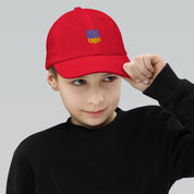 Youth baseball cap with Ukrainian Tryzub emblem, red, breathable, adjustable fit for active kids. Soft 100% bio-washed cotton.
