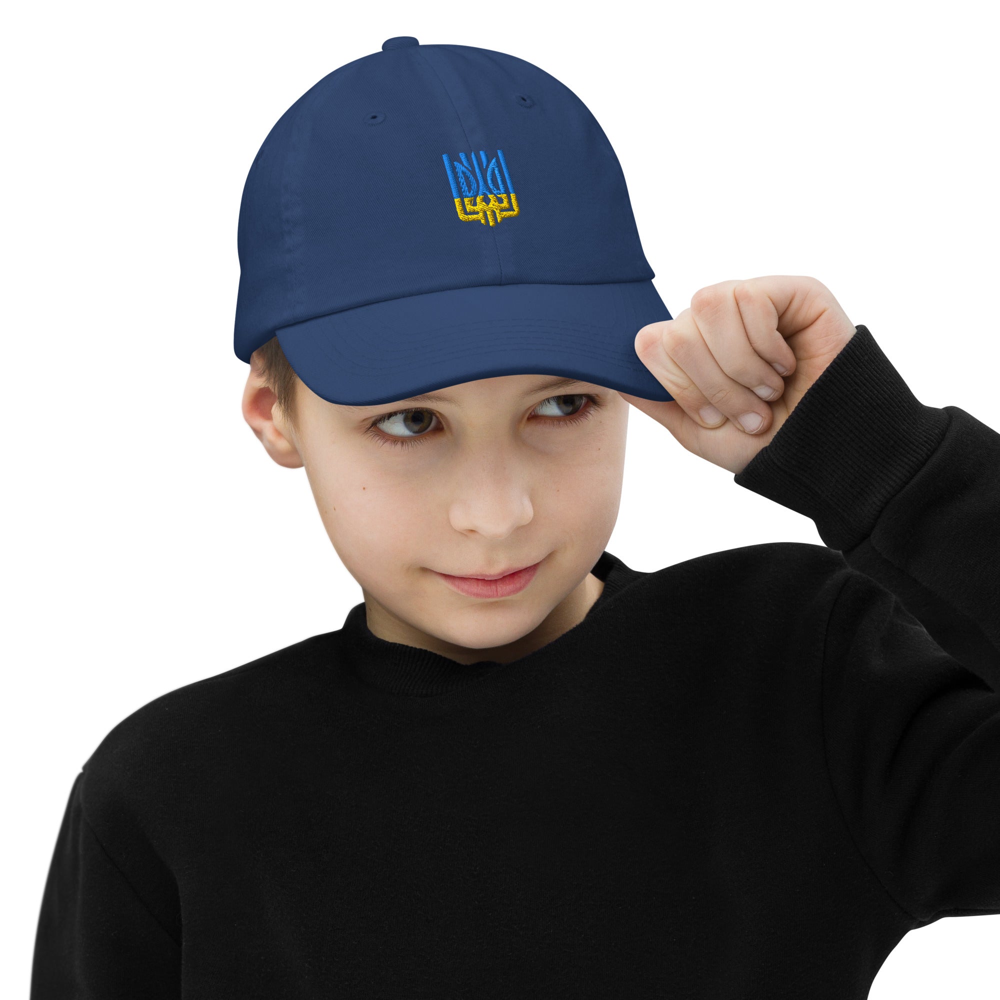 Youth wearing a blue baseball cap with Ukrainian Tryzub emblem, showcasing style and patriotism, perfect for active outdoor wear.