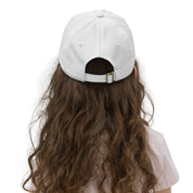 Back view of youth baseball cap with adjustable strap, worn by child, ideal for active kids. Made from breathable, bio-washed cotton twill.