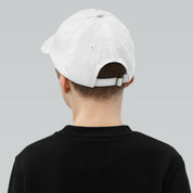 Rear view of child wearing adjustable white youth baseball cap with ventilation eyelets, perfect for active outdoor activities.