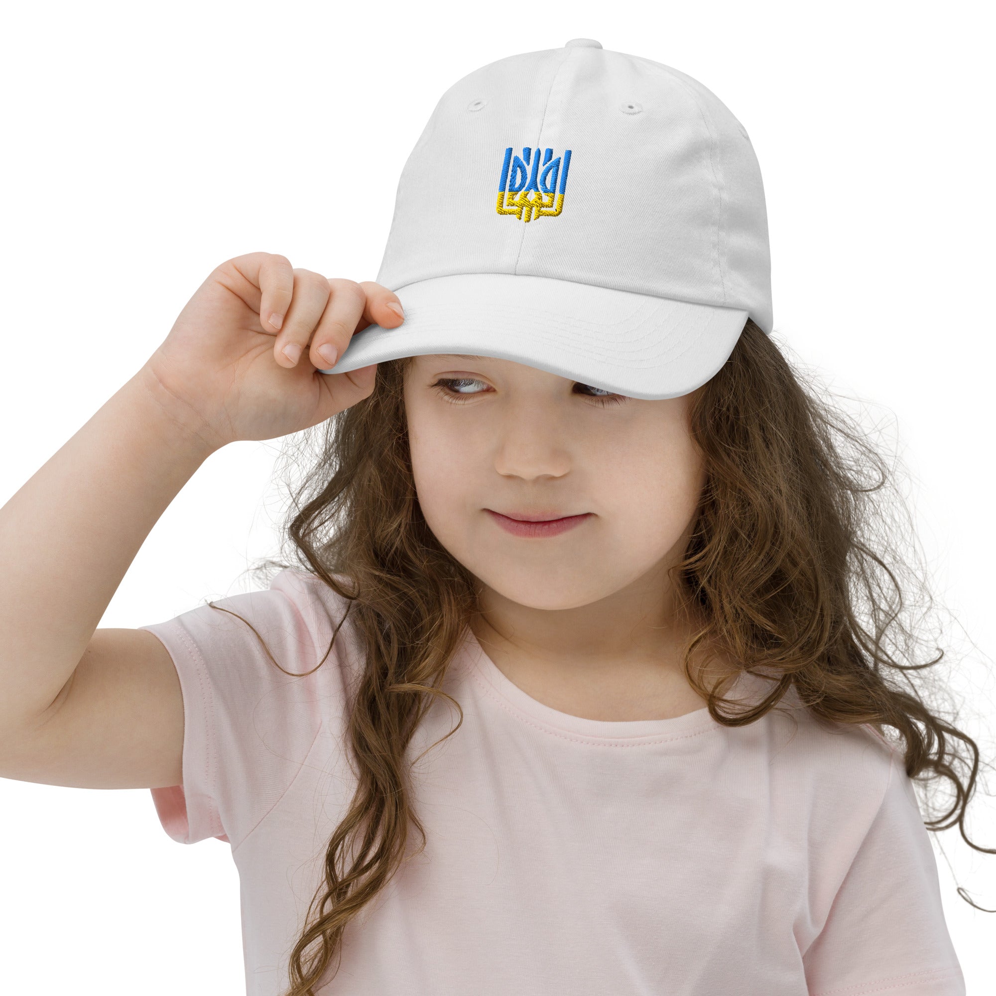 Child wearing a white baseball cap with Ukrainian Tryzub, demonstrating adjustable fit and breathable design for active kids.