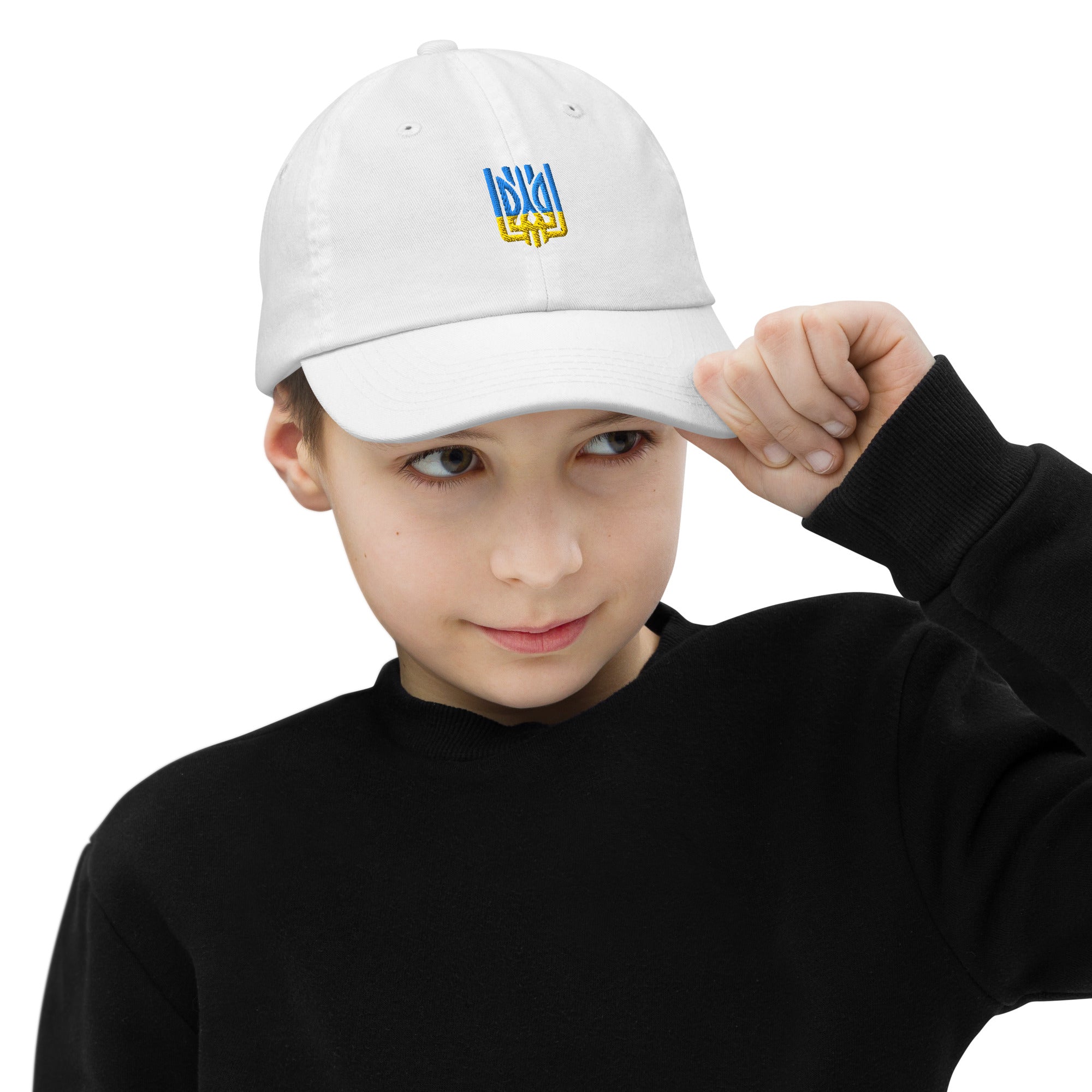 Youth wearing white baseball cap with Ukrainian Tryzub emblem, breathable and adjustable for active kids.