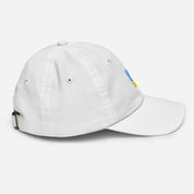Youth baseball cap with Ukrainian Tryzub emblem, white bio-washed chino cotton, adjustable strap, and ventilation eyelets for active kids.