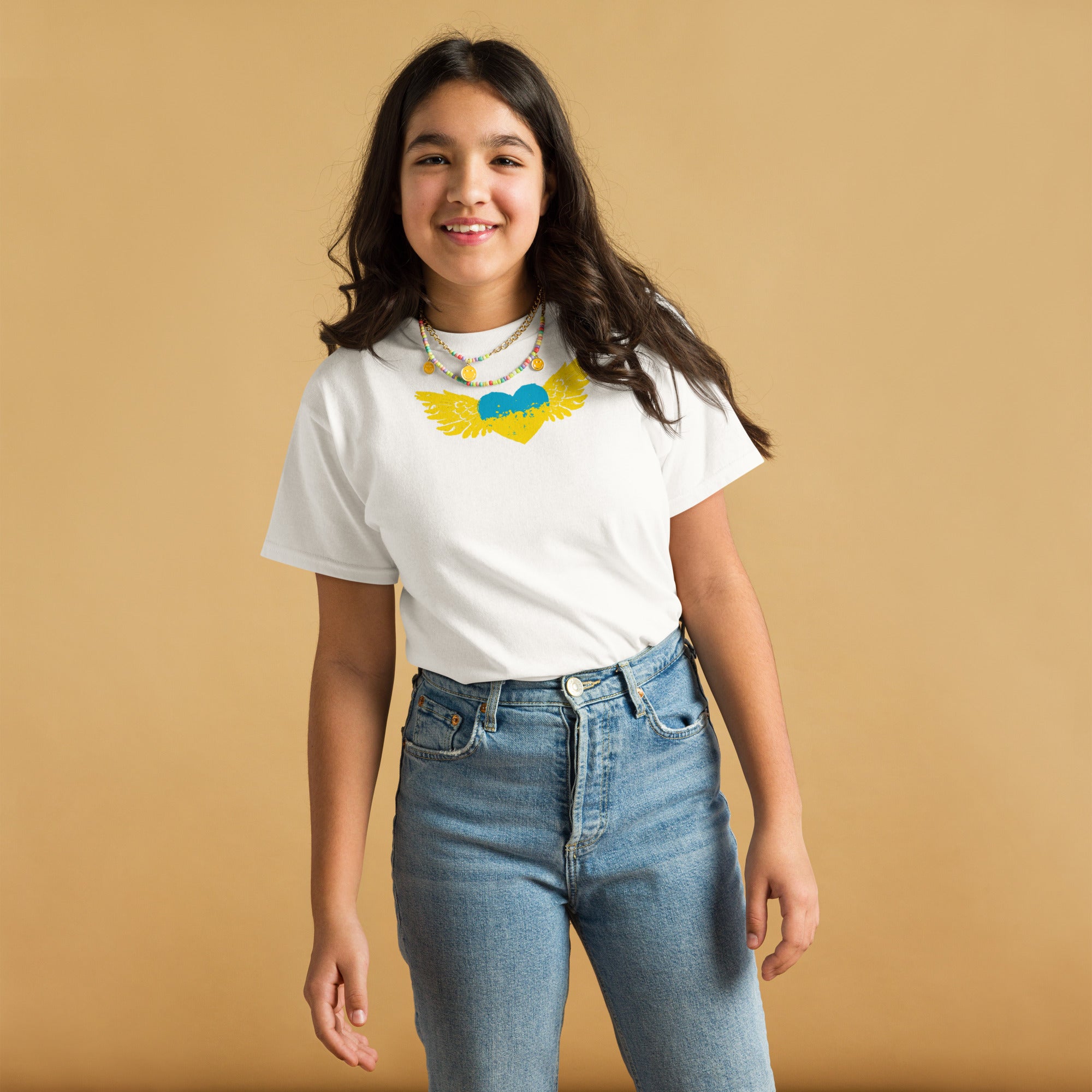 Youth wearing white T-shirt with Ukrainian Tryzub emblem, showcasing cultural pride and comfort in a casual outfit.