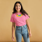 Youth wearing a pink t-shirt with Ukrainian emblem, jeans, and smiling against a beige background.