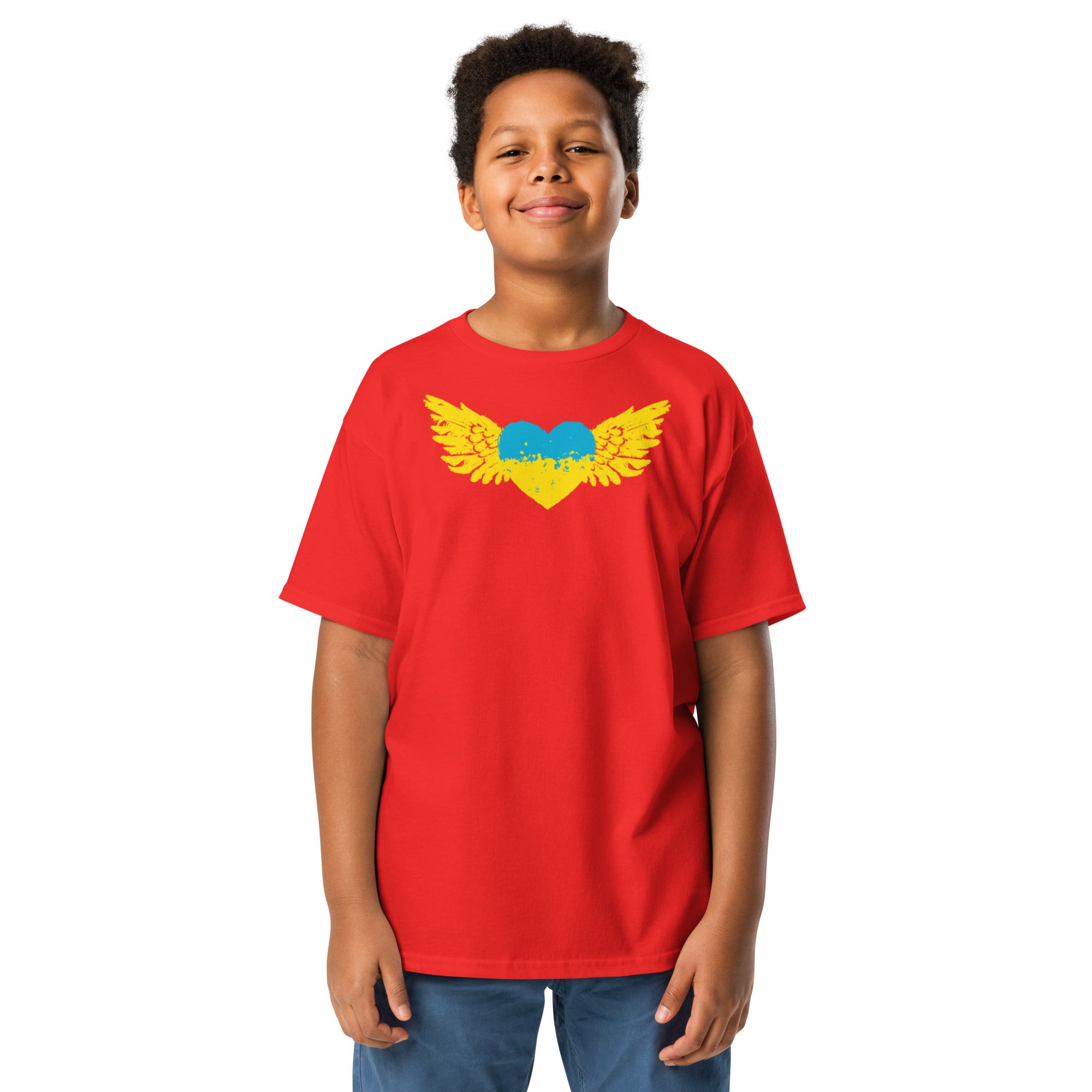 Youth wearing red t-shirt with blue and yellow Tryzub emblem, celebrating Ukrainian heritage and pride.