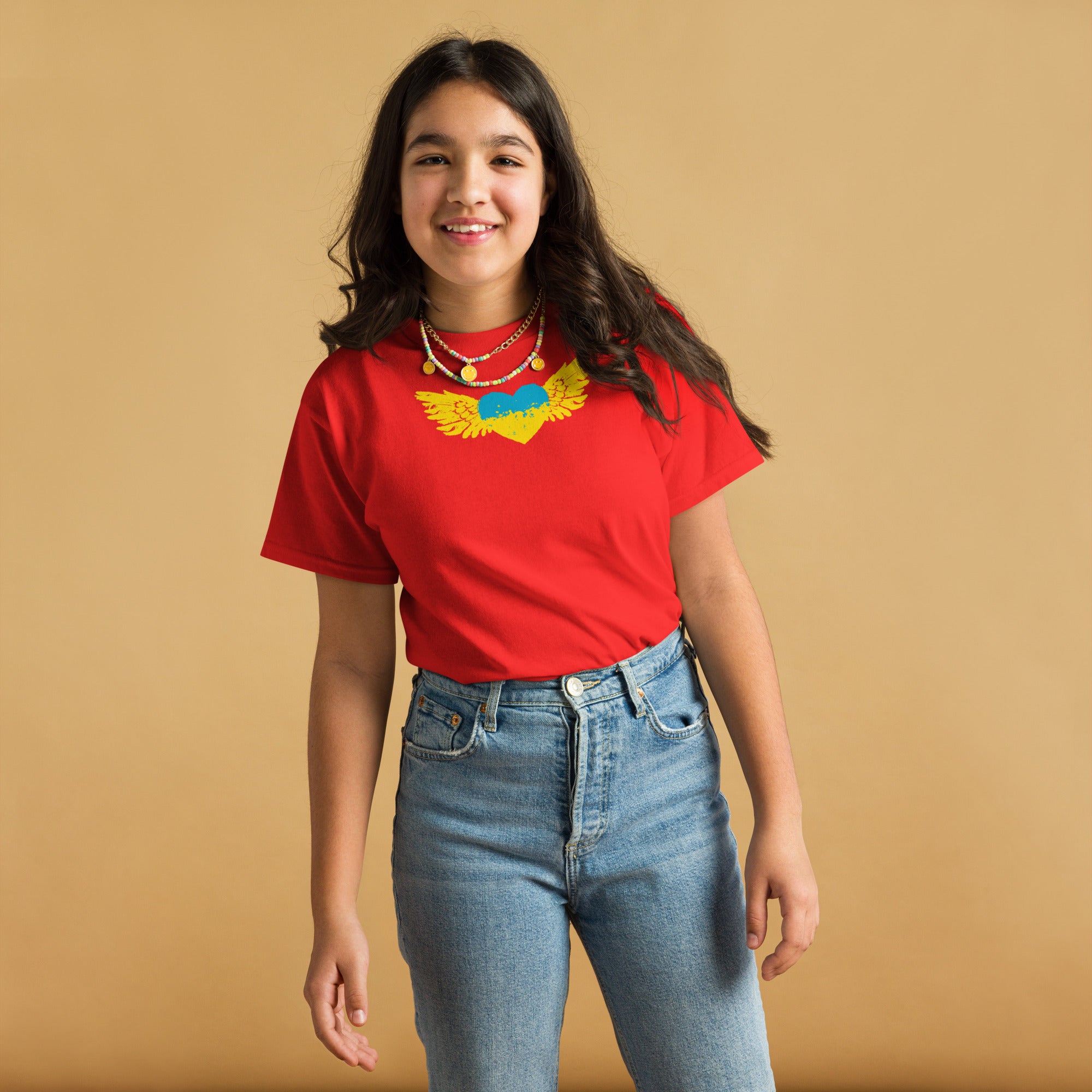 Youth wearing red Ukrainian emblem t-shirt, ideal for cultural pride and everyday wear, made from durable 100% cotton blend.