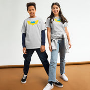 Two kids wearing youth t-shirts with Ukrainian Tryzub emblem, showcasing heritage pride and comfort for active lifestyles.