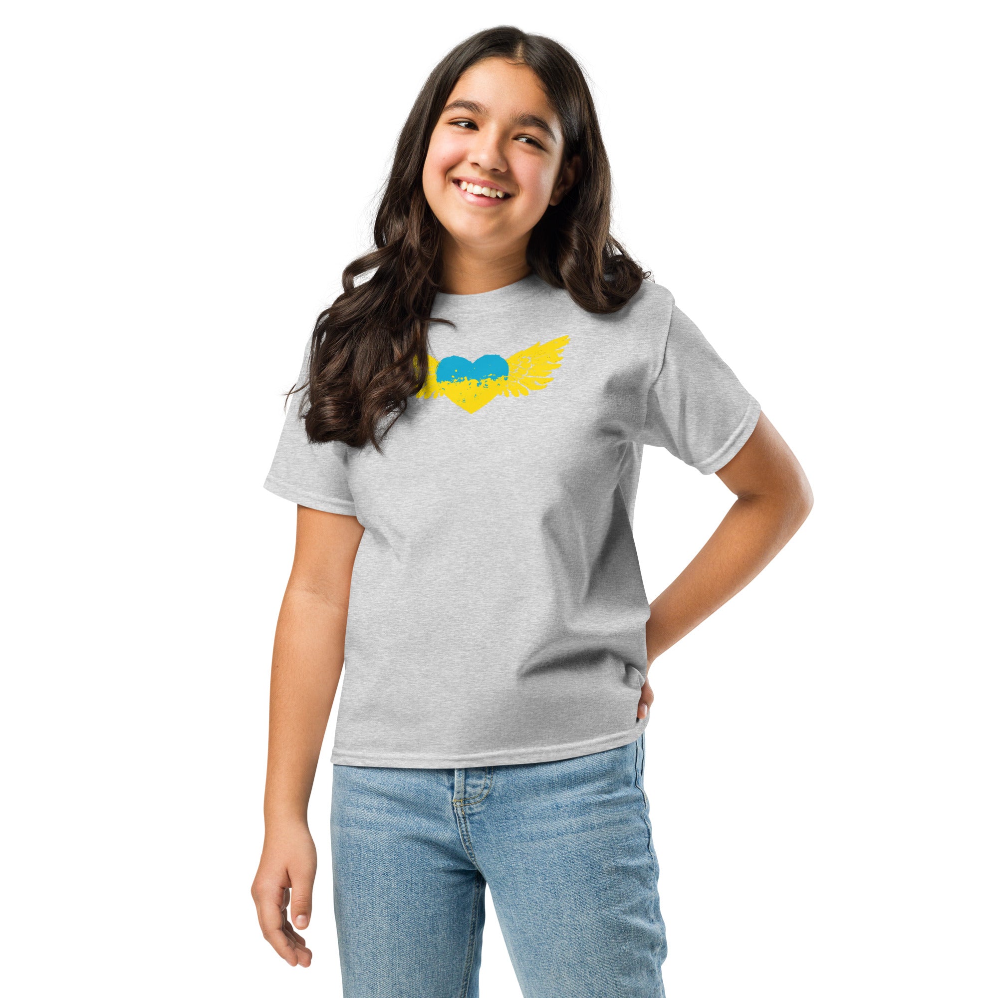 Smiling girl wearing a youth classic t-shirt with a Ukrainian Tryzub emblem and heart design, representing Ukrainian pride and heritage.