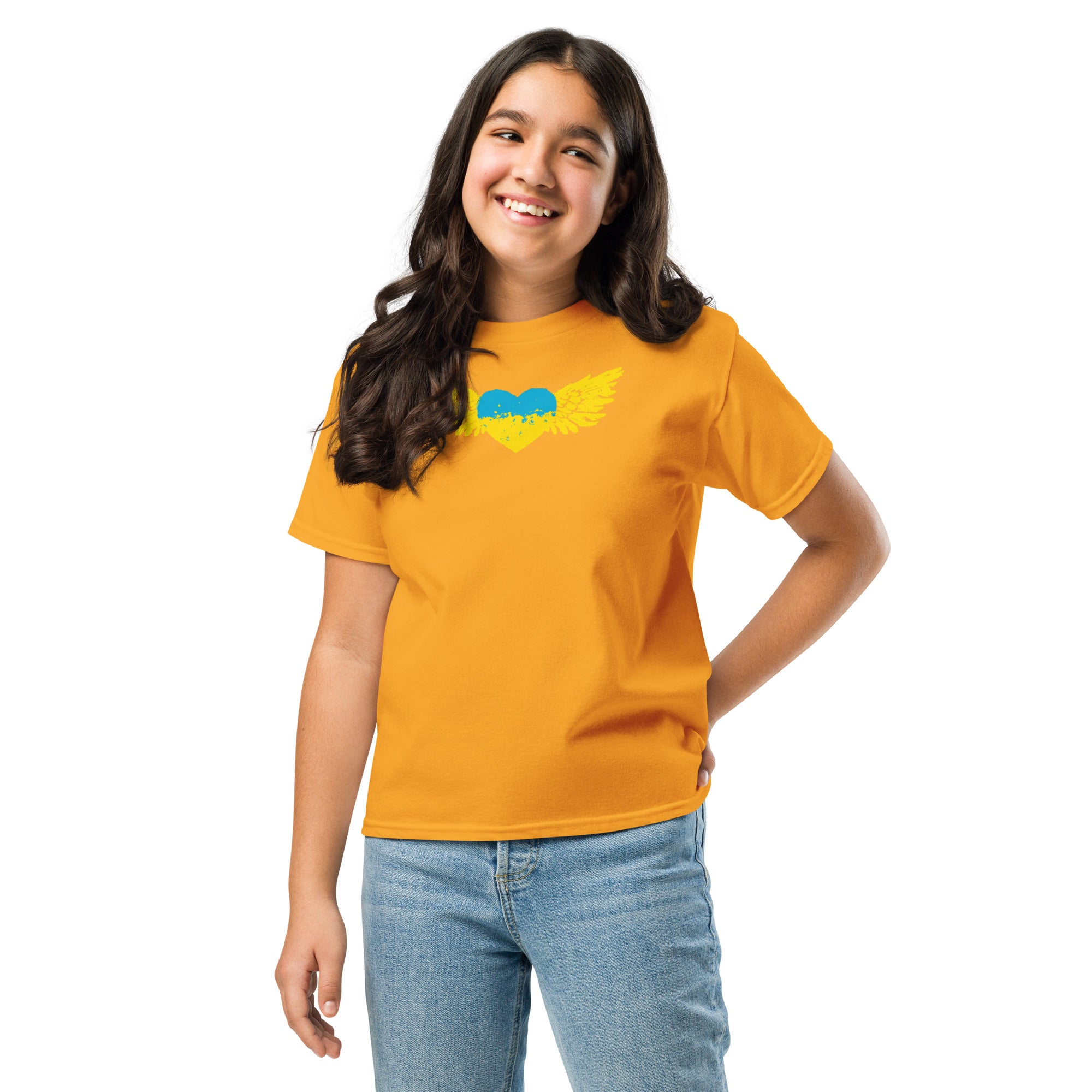 Smiling girl wearing a youth classic t-shirt with Ukrainian emblem and yellow design, showcasing cultural pride.