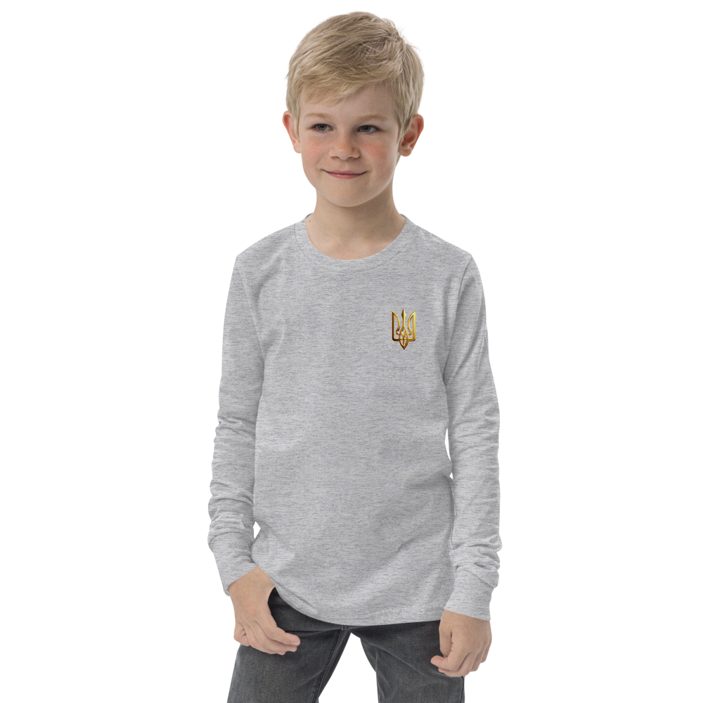 Boy wearing gray long sleeve shirt with golden Ukrainian Trizub on the heart, showcasing cultural pride and comfort.