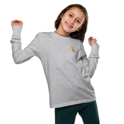 Youth wearing grey long sleeve shirt with golden Ukrainian Trizub on heart, celebrating heritage in stylish comfort.