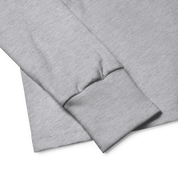 Close-up of gray long sleeve shirt with ribbed cuff showcasing soft, durable Airlume cotton fabric.