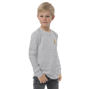 Boy wearing a grey long sleeve shirt with golden Ukrainian Trizub on heart, showcasing heritage and pride.