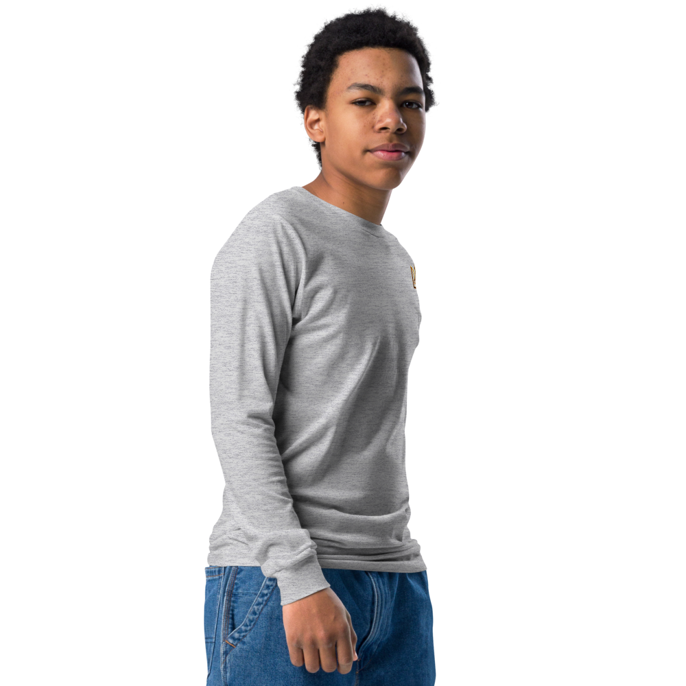 Youth wearing grey long sleeve shirt with golden Ukrainian Trizub on heart, showcasing cultural pride and comfort.