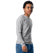 Youth wearing grey long sleeve shirt with golden Ukrainian Trizub on heart, showcasing cultural pride and comfort.