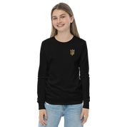 Young woman wearing black long sleeve shirt with golden Ukrainian Trizub on heart