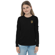 Youth wearing black long sleeve shirt with golden Ukrainian Trizub on heart, showcasing Ukrainian pride and comfort.