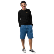 Youth wearing black long sleeve shirt with golden Ukrainian Trizub, denim shorts, and sneakers, showcasing heritage and style.