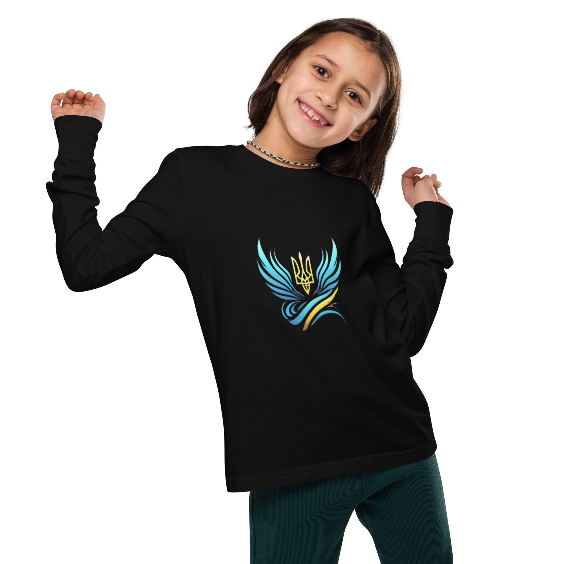 Child wearing a black youth long sleeve tee with Ukrainian Tryzub logo, smiling with arms raised, showcasing cultural pride.