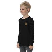 Youth wearing black long sleeve shirt with golden Ukrainian Trizub design on the heart, showcasing heritage and style.