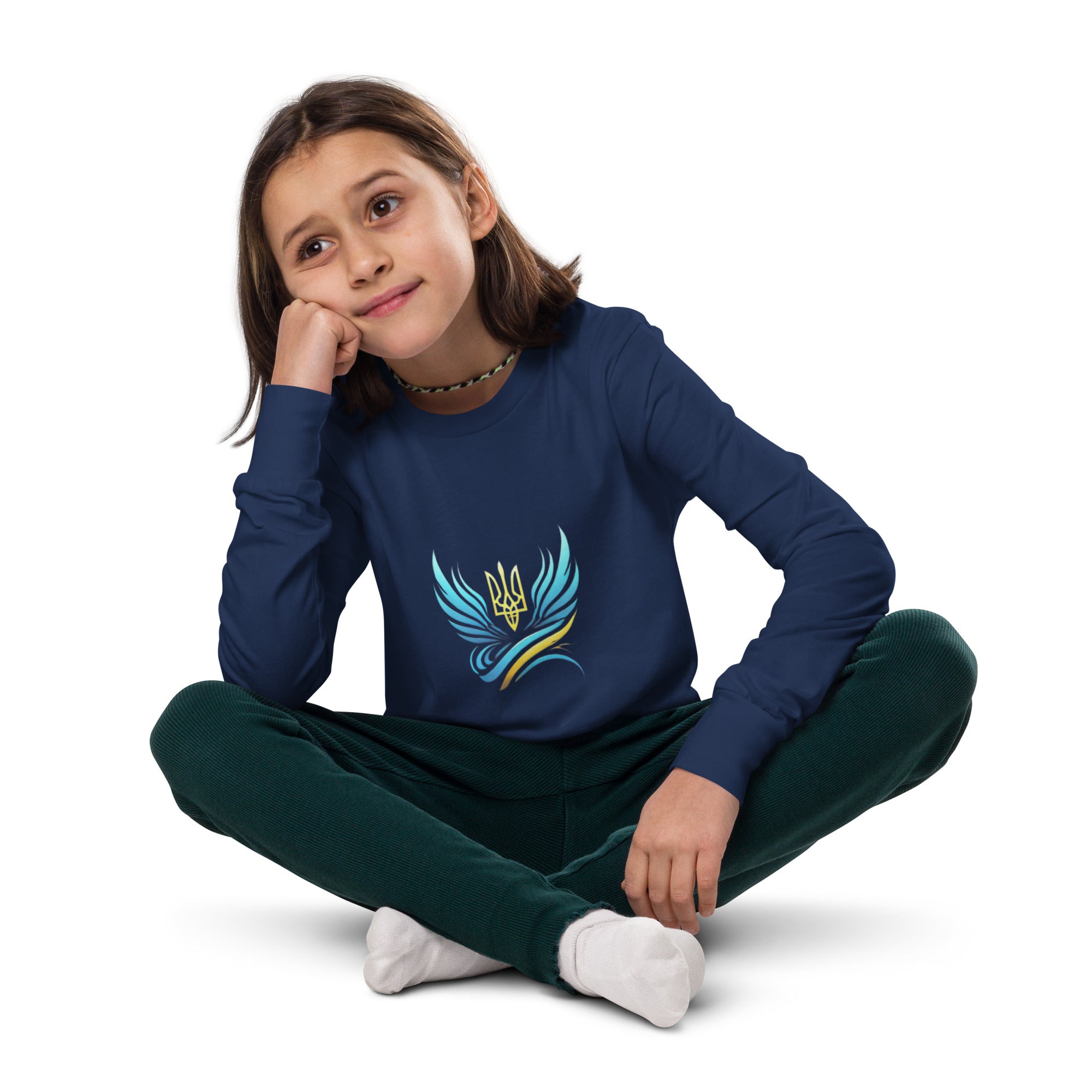 Youth wearing long sleeve tee with Ukrainian Vibe Tryzub logo, sitting cross-legged, showcasing comfort and cultural pride.