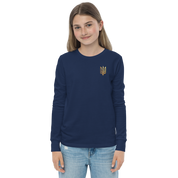Youth wearing long sleeve shirt with golden Ukrainian Trizub on heart, showcasing heritage and style in navy color.