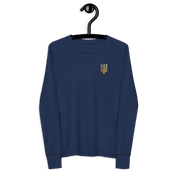 Youth long sleeve shirt with golden Ukrainian Trizub on heart, navy blue, made of soft Airlume cotton, hanging on a black hanger.